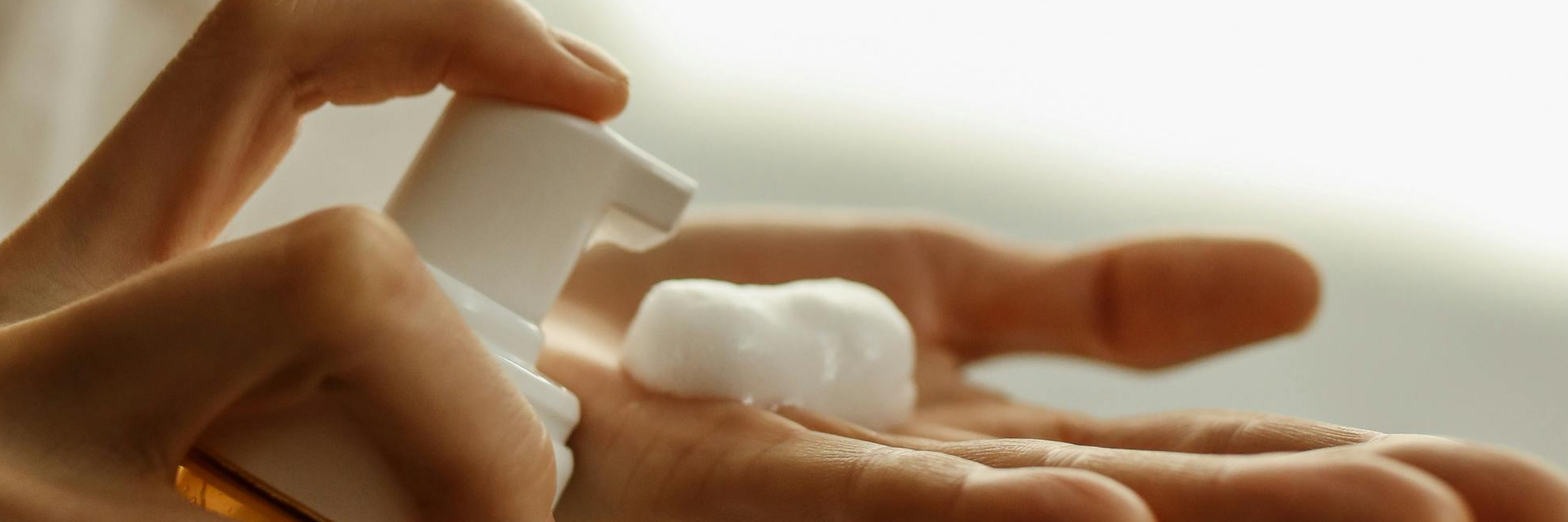 oam being dispensed from a pump bottle into a hand — representing pet dry shampoo and its common misconceptions.